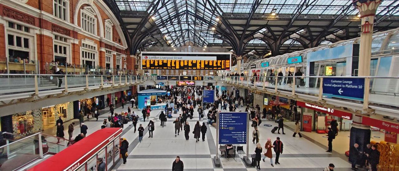 The busy main concourse of Liverpool Street station under its glass and iron roof